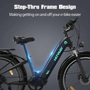 Electric bicycle featuring a step-thru frame design in navy blue, with the HITWAY logo illuminated on the side, designed for easy mounting and dismounting, set against a dark background